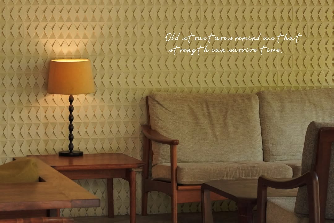 Lounge area with midcentury sofa and original diamond wall relief
